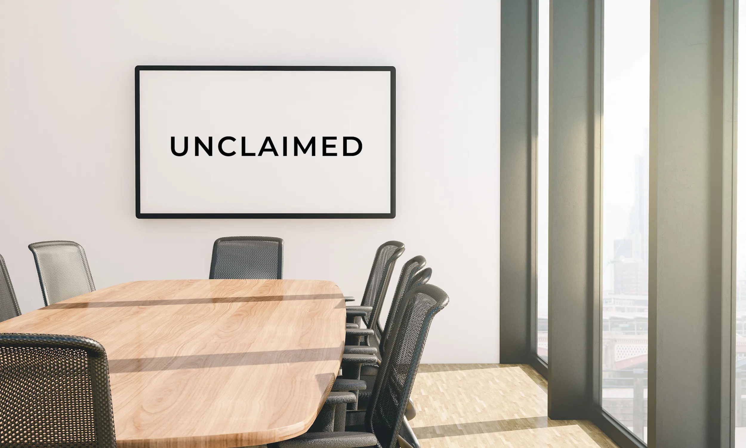 Modern conference room with Unclaimed logo on wall, symbolizing a professional digital strategy and brand planning environment.